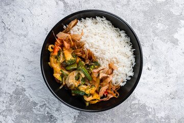 Poster - Boiled rice with stewed broccoli, green beans, tomatoes, onions, cheese and tuna shavings in a bowl, fresh dinner.