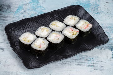 Sticker - Sushi maki rolls with crab sticks, cream cheese and apple in a plate.