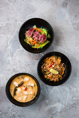 Canvas Print - Meat salad with beef, rice noodle pad thai with chicken and corn soup with pork.