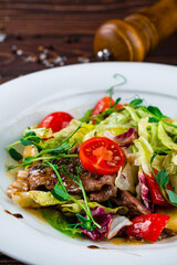 Wall Mural - Salad with cherry tomatoes, pork, lettuce and green peas, fresh dish.