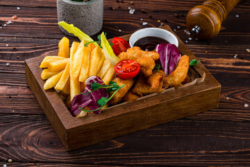 Canvas Print - Breaded chicken fillet with French fries, cherry tomatoes, lettuce and sauce, snacks.