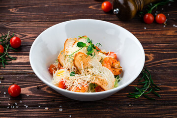 Canvas Print - Caesar salad with shrimps, parmesan cheese, eggs, lettuce, tomatoes and croutons, Italian dinner.