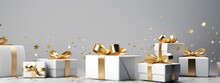 White And Gold Gift Boxes On Grey Background With Confetti
