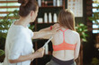 © Alliance - female therapist checking neck condition during examination