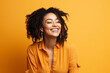 © koala studio - Cheerful african american young woman with afro hairstyle laughing