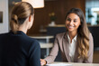© koala studio - Portrait of smiling businesswoman talking to female colleague in office. Business meeting concept