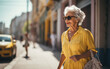 Senior woman walking alone. Elderly lady outside in the city.