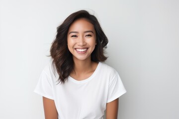 Wall Mural - Young Asian woman smiling portrait white background