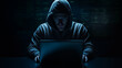© Terriology - Creepy Hacker on Laptop in Dark Room