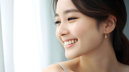 Portrait of a smiling girl in minimalistic earrings