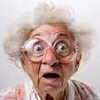 The Face Of A Surprised Elderly Woman In Fashionable Glasses