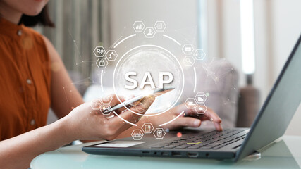 System Applications and Product (SAP). Program helps manage business to access information quickly accurately. Woman using laptop holding magnifying glass with SAP text inside. An icon on background.