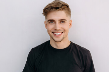 Wall Mural - closeup photo portrait of a handsome blonde scandinavian man smiling with clean teeth. for a dental ad.