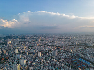 Panoramic view of Saigon, Vietnam from above at Ho Chi Minh City's central business district. Cityscape and many buildings, local houses, bridges, rivers