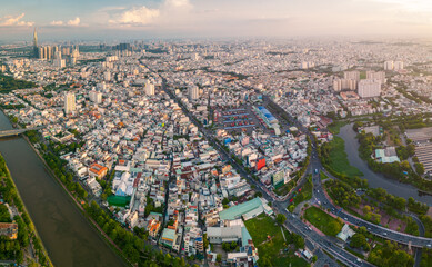 Panoramic view of Saigon, Vietnam from above at Ho Chi Minh City's central business district. Cityscape and many buildings, local houses, bridges, rivers