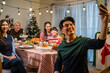 © Kawee - Asian family taking a photo while celebrate christmas party together.