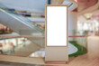 © Kandl Studio - Vertical OOH out of home poster display in retail environment. Advertising digital screen in shopping mall. Out of focus bokeh effect in background
