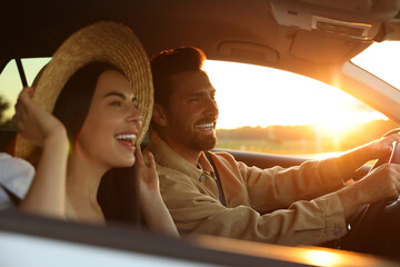 Wall Mural - Happy couple enjoying trip together by car, selective focus