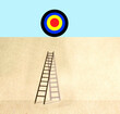 © Westend61 - Ladder reaching to sports target lying on top of wall