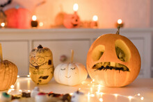Pumpkin Decorations Near String Light On Table At Home