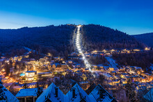 Germany, Baden-Wurttemberg, Bad Wildbad, Illuminated town in Black Forest range at winter dusk