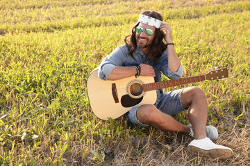 Poster - Happy hippie man with guitar in field, space for text