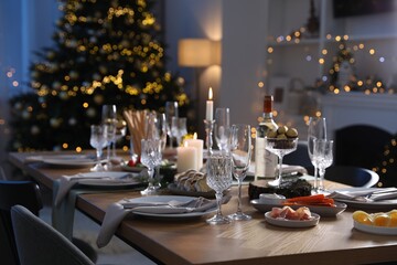 Wall Mural - Christmas table setting with festive decor and dishware in room