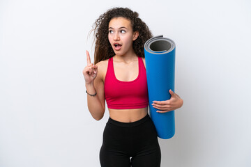 Wall Mural - Young sport Arab woman going to yoga classes while holding a mat isolated on white background thinking an idea pointing the finger up