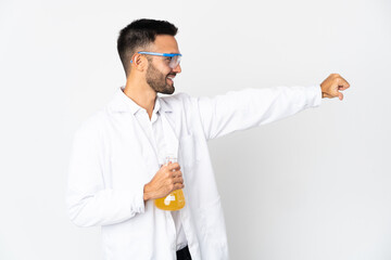 Young scientific man isolated on white background giving a thumbs up gesture