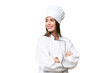 © luismolinero - Young chef caucasian woman over isolated background with arms crossed and happy