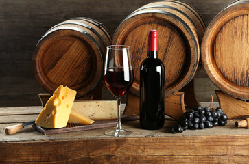 Wall Mural - Winemaking. Composition with tasty wine and barrels on wooden table