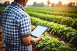 Man farmer checking and holding a digital tablet