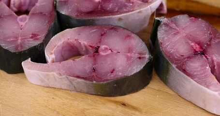 Wall Mural - pieces of sea fish during cooking, raw yellow-tailed fish during cutting for cooking