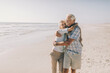 © Marko Geber - Happy senior couple hugging at the beach