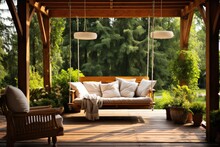 Beautiful Wooden Terrace With Garden Furniture And Swing Surrounded By Greenery On A Warm, Summer Day With Warm Sun Light