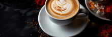 Wide Panoramic Top View Photo Of A Cappuccino Coffee Cup With Cream Design On It And A Saucer In White Background