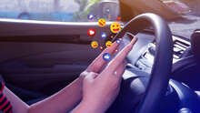 Social Media And Online Digital Concept, Woman Using Smart Phone Sending Emojis With Social Media In Car.