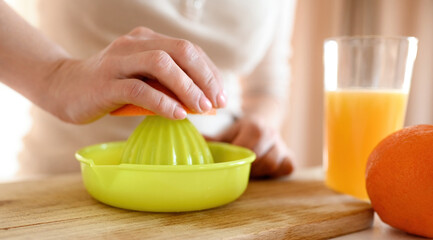 Poster - Girl making orange juice at kitchen