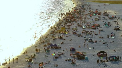 Wall Mural - Famous Siesta Key beach with soft white sand in Sarasota, USA. Many people enjoying vacation time bathing in warm gulf water and tanning under hot Florida sun at sunset