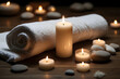 The image of a luxury spa with towels, lit candles, and special spa stones side by side in dim light