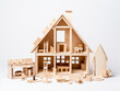 Wooden house made of plywood on white background. Home construction. AI