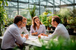 © EricMiguel - Business team in a meeting inside a greenhouse, discussing strategies on sustainability and leadership.