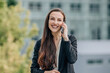 © carballo - business woman outdoors talking on mobile phone