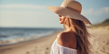 Side View Of Attractive Young Woman In Straw Hat On Sandy Beach 