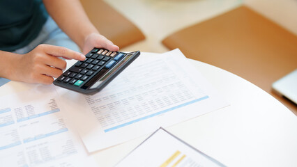 Wall Mural - Female calculating personal financial for future plan at her home, taxes payment