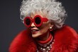 © olegganko - an elderly woman in red sunglasses smiling