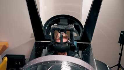 Wall Mural - guy sitting in flight simulator of military plane wearing virtual reality glasses during flight entertainment