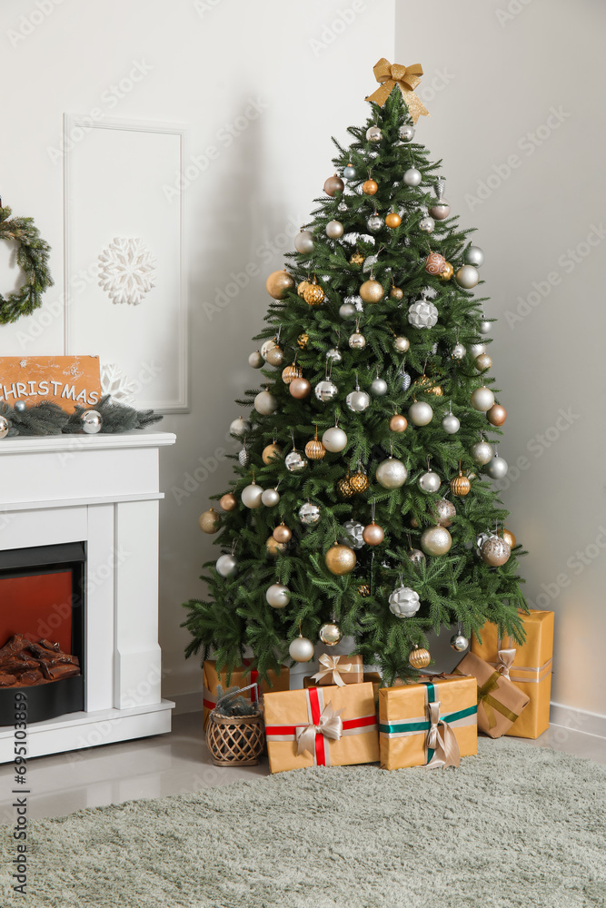Interior of living room with Christmas tree, gift boxes and fireplace