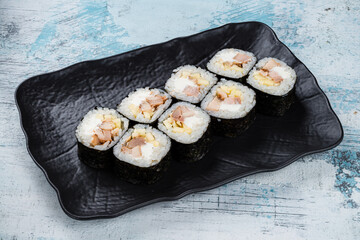 Sticker - Sushi maki rolls with chicken fillet, cream cheese and apple in a plate.