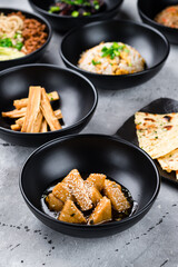 Sticker - Fried tofu with honey, rice scrambled eggs, Dan Dan noodles with pork, Fuju asparagus marinated in rice vinegar and Naan flatbread.